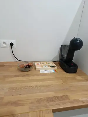 a desk with a lamp and books on a wooden floor at APARTAMENTO LUPA in Cádiz