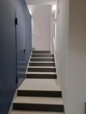 a staircase in a building with white walls and a stair case at APARTAMENTO LUPA in Cádiz