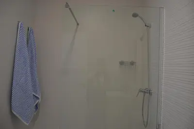 a shower with a glass door in a bathroom at APARTAMENTO LUPA in Cádiz