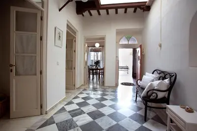 a living room with a black and white checkered floor at Barroso 4 by 7Escalones in Rota