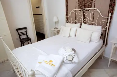 a bedroom with a white bed with towels on it at Barroso 4 by 7Escalones in Rota
