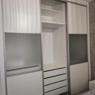 a closet with white cabinets and a mirror at Ohana in San Fernando