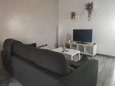a living room with a couch and a tv at Ohana in San Fernando