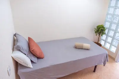 a bed in a room with pillows on it at Apartamento AGUADULCE in Sanlúcar de Barrameda