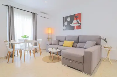 a living room with a couch and a table at Casa Sumariva in Sanlúcar de Barrameda