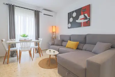 a living room with a couch and a table at Casa Sumariva in Sanlúcar de Barrameda