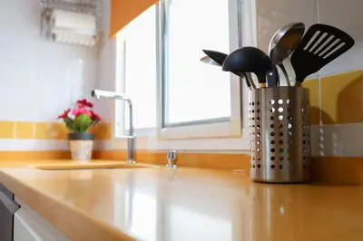 a kitchen counter with a container of utensils on it at Casa Sumariva in Sanlúcar de Barrameda