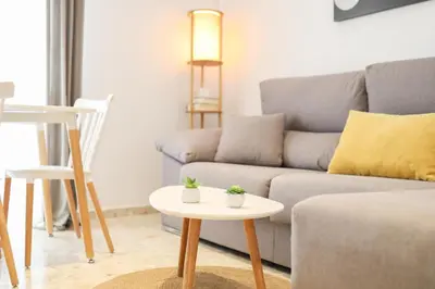 a living room with a couch and a table at Casa Sumariva in Sanlúcar de Barrameda