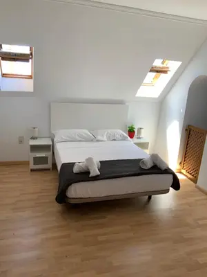 a bedroom with a bed in a white room at DUPLEX BAHIA SuR RESERVA DE CONFI-ANZA in San Fernando