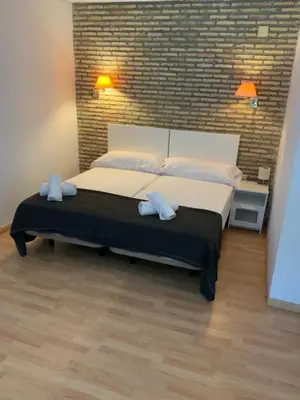 a room with a bed sitting on a wooden floor at DUPLEX BAHIA SuR RESERVA DE CONFI-ANZA in San Fernando