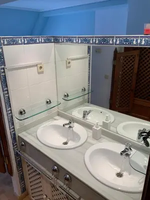 a bathroom with two sinks and a mirror at DUPLEX BAHIA SuR RESERVA DE CONFI-ANZA in San Fernando