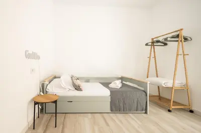 a bedroom with a bed and a swing at Suite Catedral Little Apartments in Cádiz