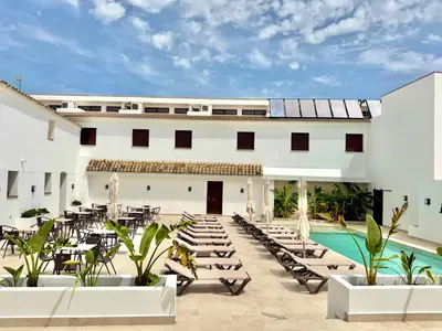 a resort with a pool and tables and chairs at El Mirador del Valle in San Jose del Valle
