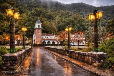 a wet street in front of a building with lights at El Mirador del Valle in San Jose del Valle