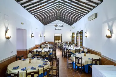 a dining room with tables and chairs in it at El Mirador del Valle in San Jose del Valle