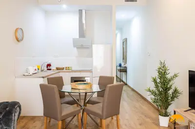 a kitchen and dining room with a table and chairs at Tailor's Home by Cadiz Time in Cádiz