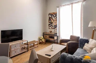 a living room with a couch and a tv at Tailor's Home by Cadiz Time in Cádiz