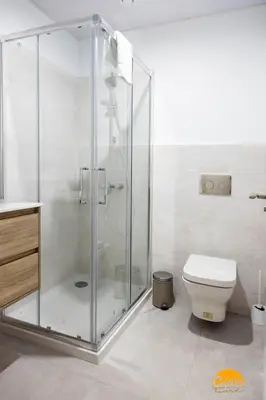 a bathroom with a glass shower and a toilet at Carpenter's Home by Cadiz Time in Cádiz