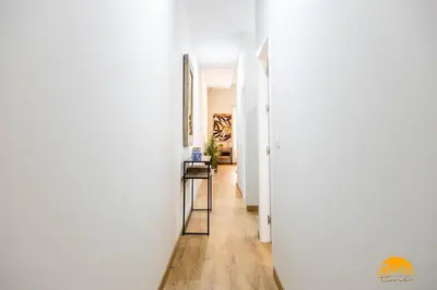 a hallway with white walls and wood floors at Carpenter's Home by Cadiz Time in Cádiz
