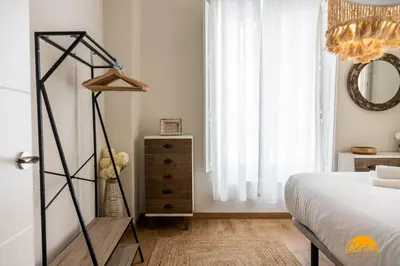a bedroom with a bed and a dresser and a mirror at Carpenter's Home by Cadiz Time in Cádiz