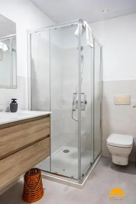 a glass shower in a bathroom with a toilet at Carpenter's Home by Cadiz Time in Cádiz