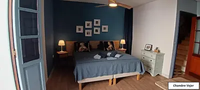 a bedroom with a bed with pictures on the wall at Oasis de Bornos Chambres in Bornos