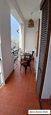 a balcony of a house with a table and chairs at Oasis de Bornos Chambres in Bornos
