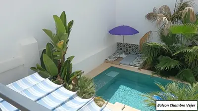 a small swimming pool in a room with plants at Oasis de Bornos Chambres in Bornos