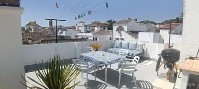 a patio with a table and chairs on a balcony at Oasis de Bornos Chambres in Bornos