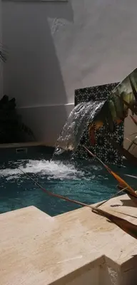 a person is spraying water on top of a pool at Oasis de Bornos Chambres in Bornos