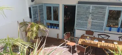 a patio with a wooden table and chairs on a porch at Oasis de Bornos Chambres in Bornos