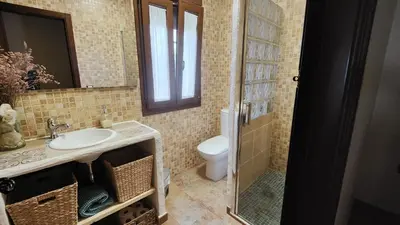 a bathroom with a sink and a toilet at Villa Zahara in Chiclana de la Frontera