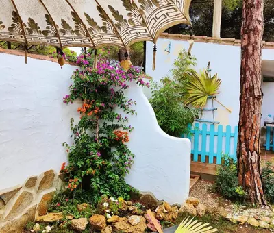 a garden with flowers on a white wall at Villa Zahara in Chiclana de la Frontera