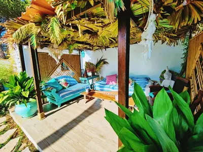 a room with a bed and an umbrella at Villa Zahara in Chiclana de la Frontera