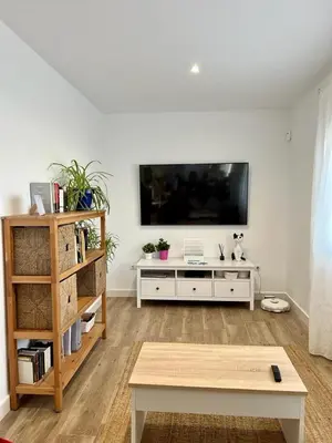 a living room with a flat screen tv on a wall at Villa Olivia con Piscina, Jardin y Parking in Chiclana de la Frontera