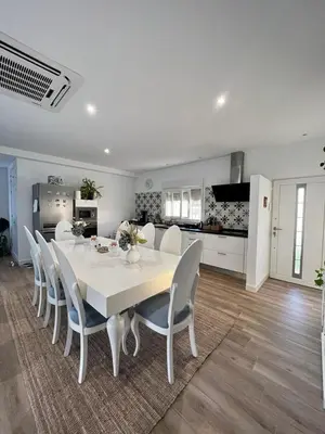 a white dining room with a white table and chairs at Villa Olivia con Piscina, Jardin y Parking in Chiclana de la Frontera