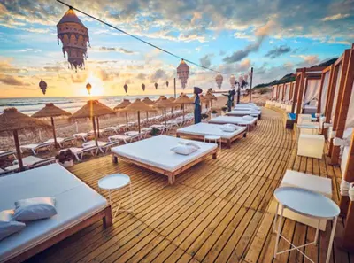 a deck of a cruise ship with tables and chairs at Villa Olivia con Piscina, Jardin y Parking in Chiclana de la Frontera