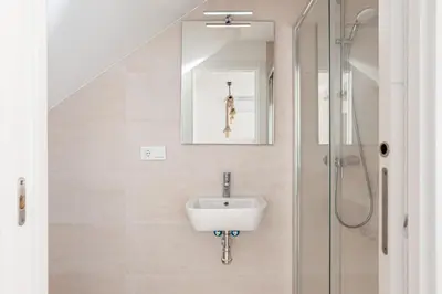 a bathroom with a sink and a shower at Casa Playa Andres in Conil de la Frontera