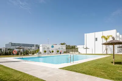 a swimming pool in the middle of a building at Casa Playa Andres in Conil de la Frontera