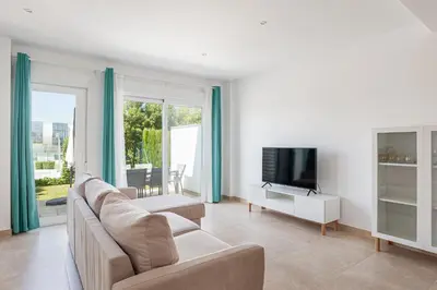 a living room with a couch and a television at Casa Playa Andres in Conil de la Frontera