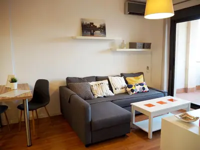 a living room with a couch and a table at Loft con encanto cerca del centro + Parking in Jerez de la Frontera