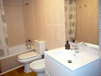 a bathroom with a white toilet and a sink at Loft con encanto cerca del centro + Parking in Jerez de la Frontera