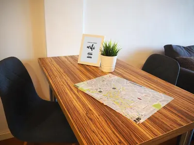 a wooden table with a map and a plant on it at Loft con encanto cerca del centro + Parking in Jerez de la Frontera