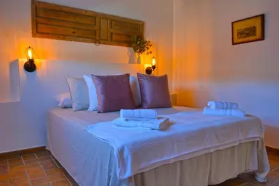 a bed in a room with two towels on it at La Esperanza in Medina Sidonia