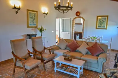 a living room with a couch and chairs and a table at La Esperanza in Medina Sidonia