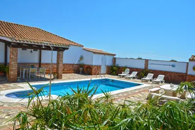 a villa with a swimming pool and a patio at La Esperanza in Medina Sidonia