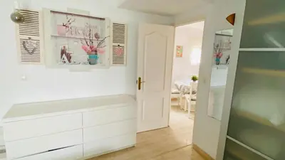a kitchen with white cabinets and a white door at Ático Cádiz Playa in Cádiz