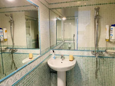a bathroom with a sink and a mirror at Ático Cádiz Playa in Cádiz