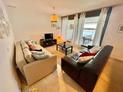 a living room with two couches and a television at GATU PREMIUM Racimo, terraza, aire ac, piscina comun, wifi y parking 