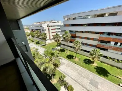 a view from a window of a building with palm trees at GATU PREMIUM Racimo, terraza, aire ac, piscina comun, wifi y parking 